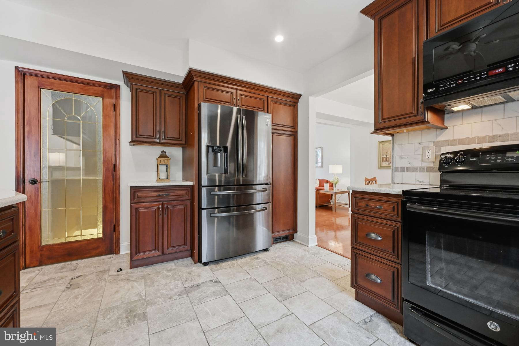 8329 Sail Court Pasadena, MD 21122 - Photo 12 of 61 a kitchen with stainless steel appliances granite countertop a refrigerator and a stove