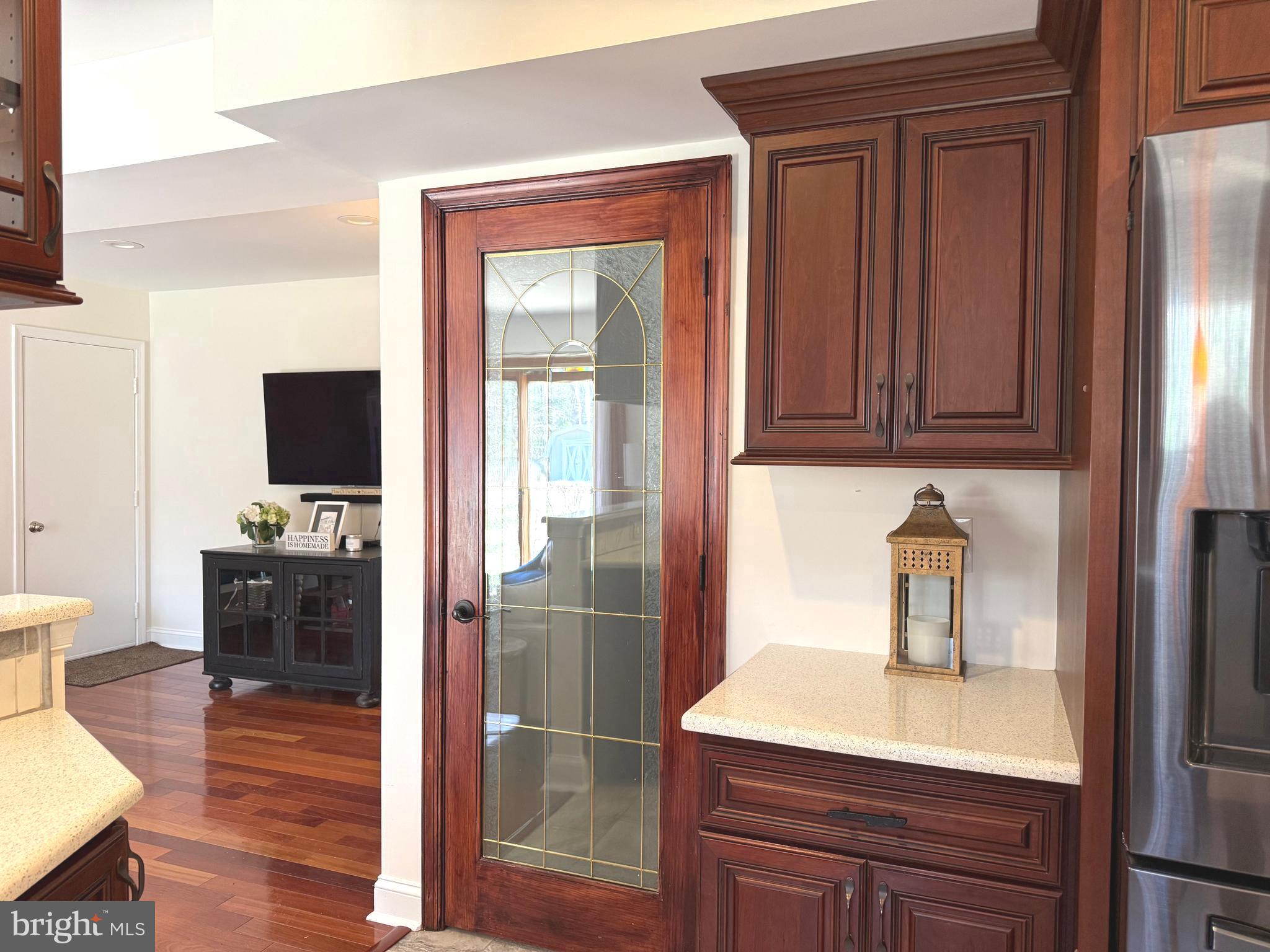 8329 Sail Court Pasadena, MD 21122 - Photo 14 of 61 a hallway with a sink a mirror and wooden floor