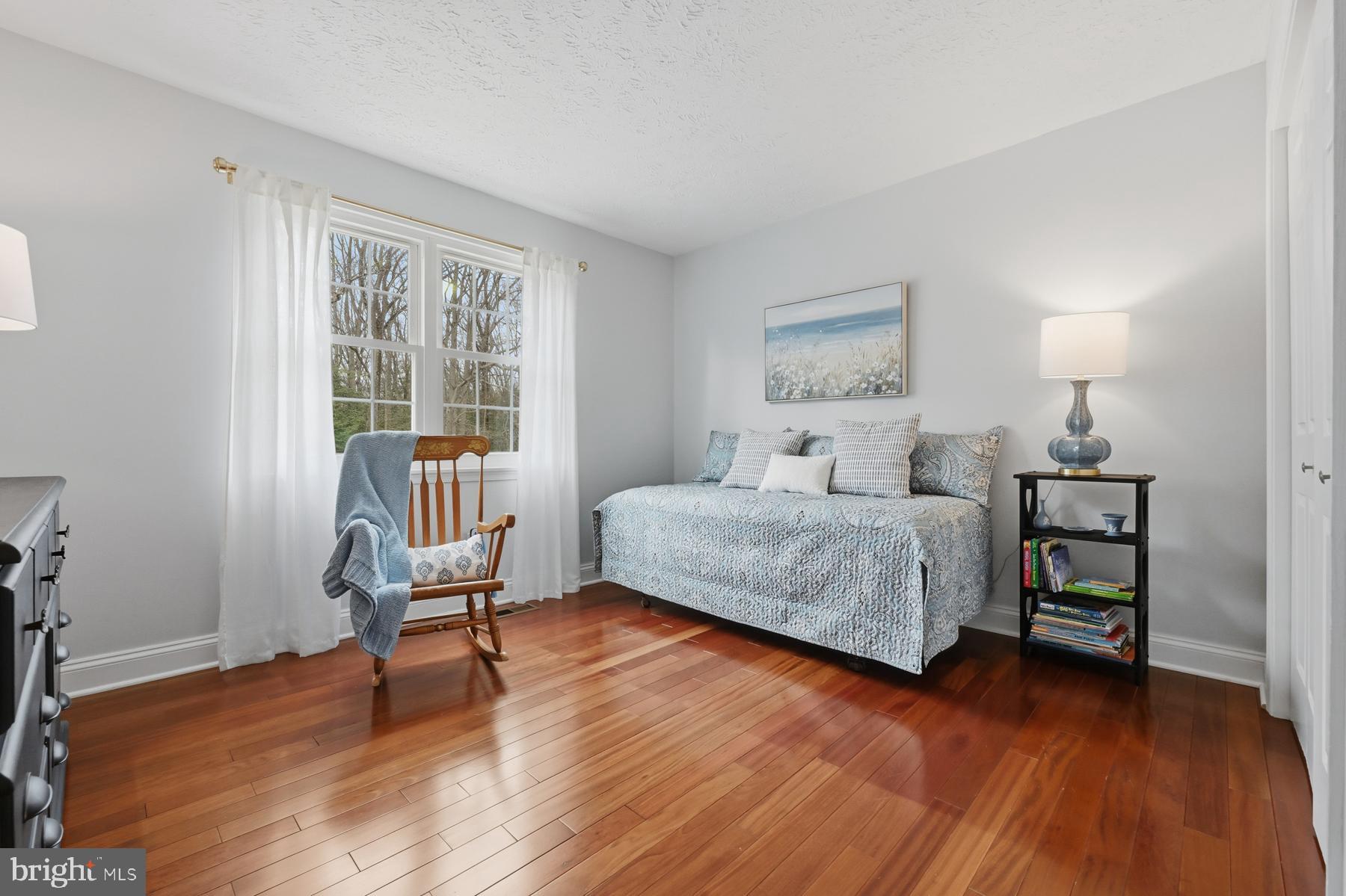8329 Sail Court Pasadena, MD 21122 - Photo 32 of 61 a bedroom with a bed wooden floor and a window