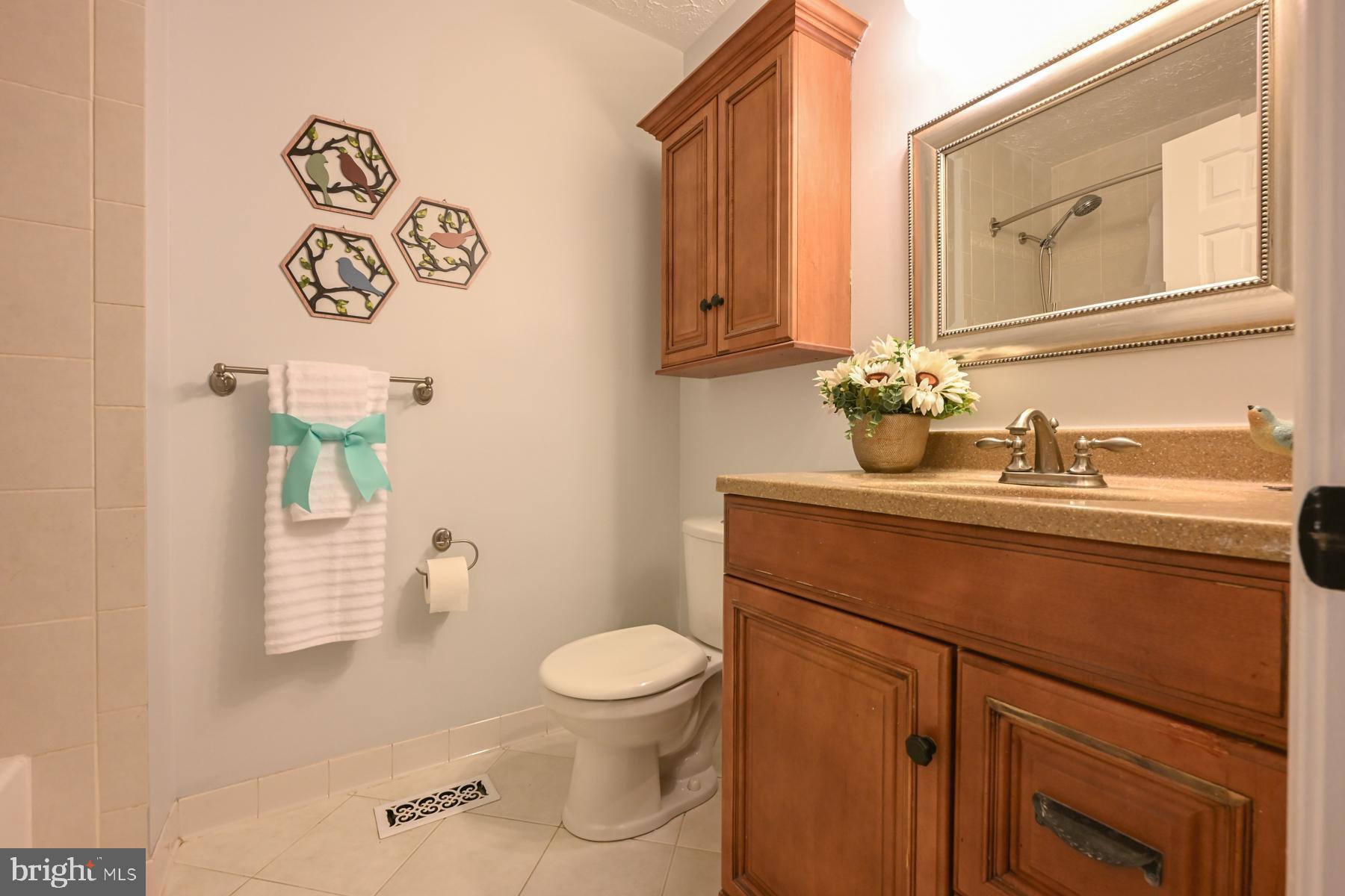 8329 Sail Court Pasadena, MD 21122 - Photo 37 of 61 a bathroom with a toilet sink and mirror