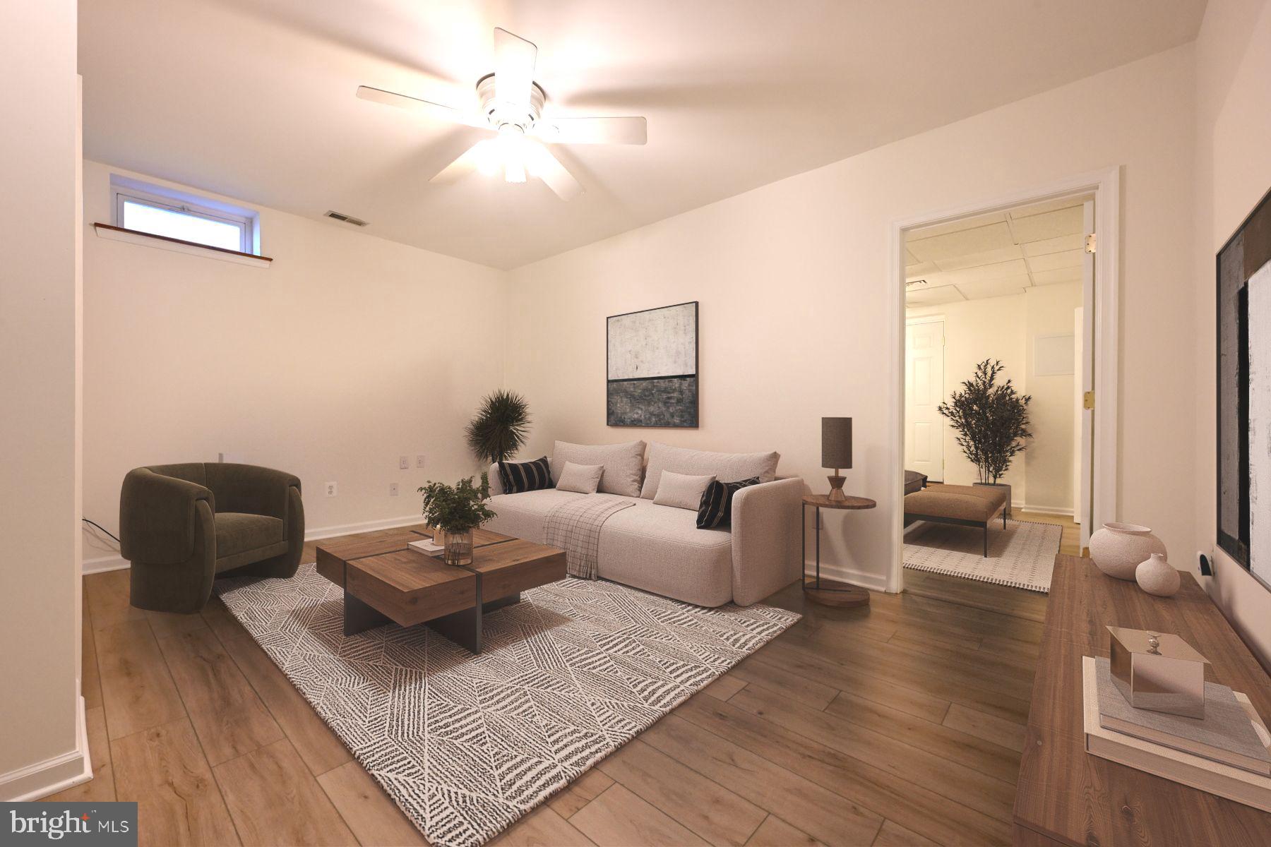 8329 Sail Court Pasadena, MD 21122 - Photo 38 of 61 a living room with furniture and a wooden floor