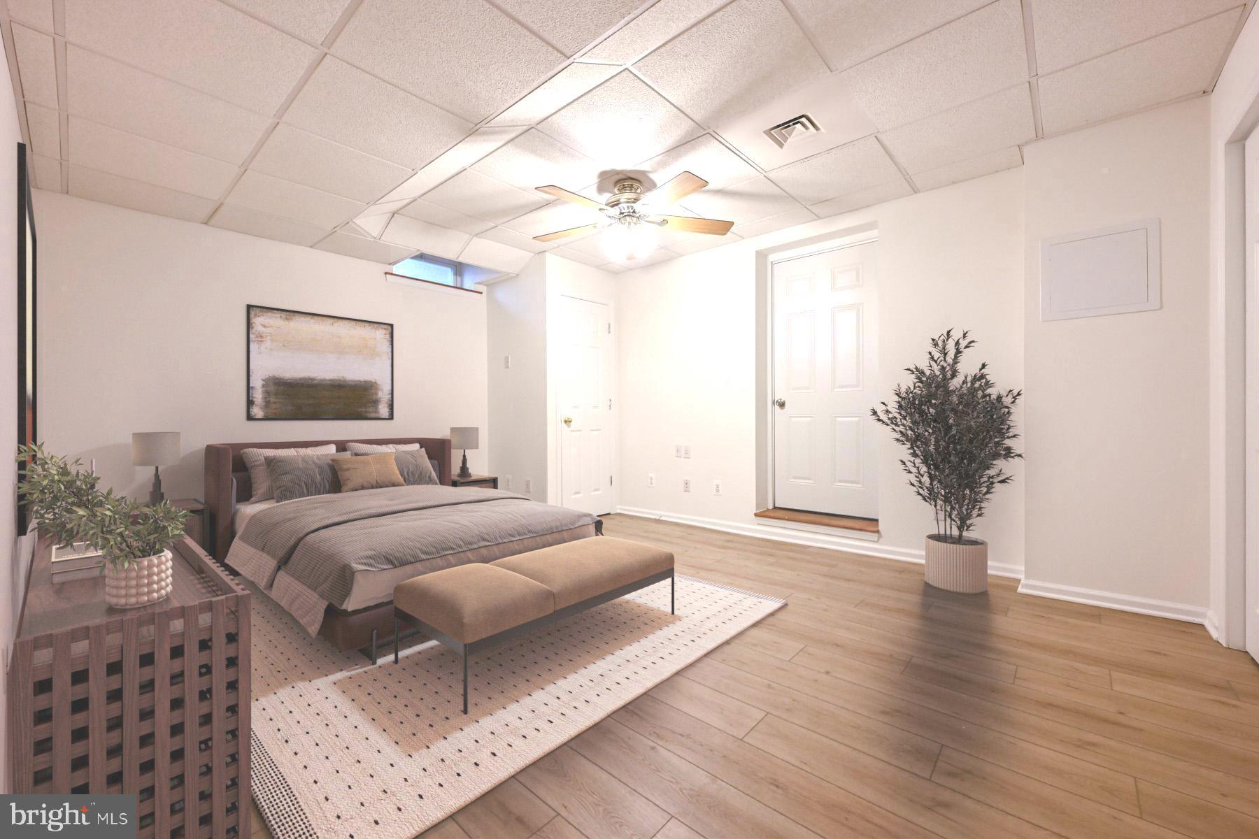 8329 Sail Court Pasadena, MD 21122 - Photo 40 of 61 a spacious bedroom with a large bed and a chandelier