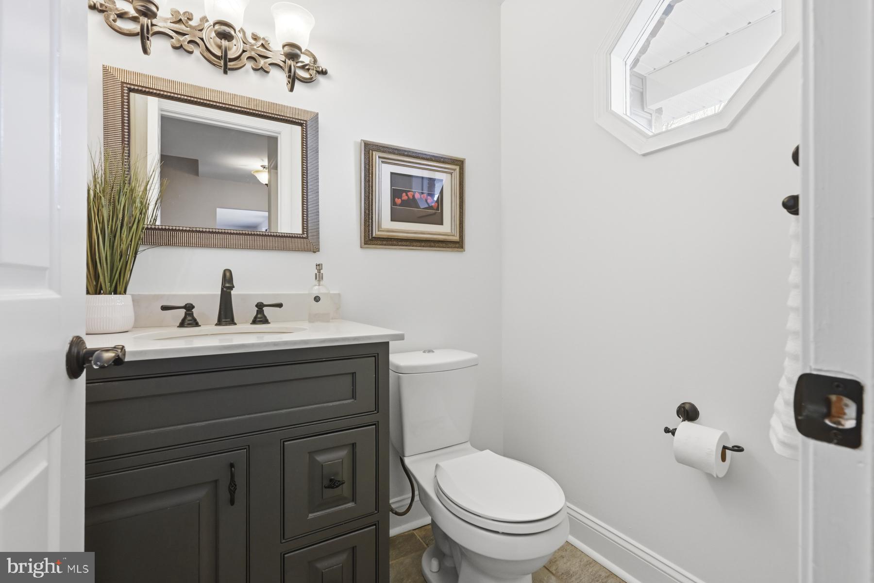 8329 Sail Court Pasadena, MD 21122 - Photo 5 of 61 a bathroom with a toilet sink and mirror