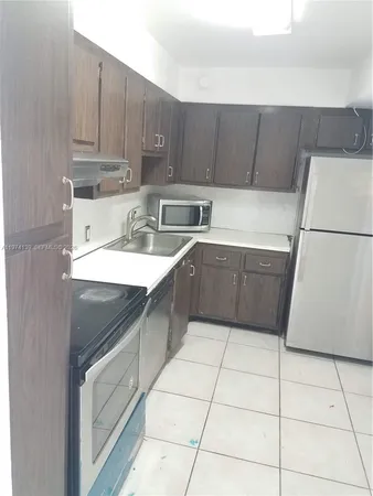 a kitchen with a cabinets sink and white appliances