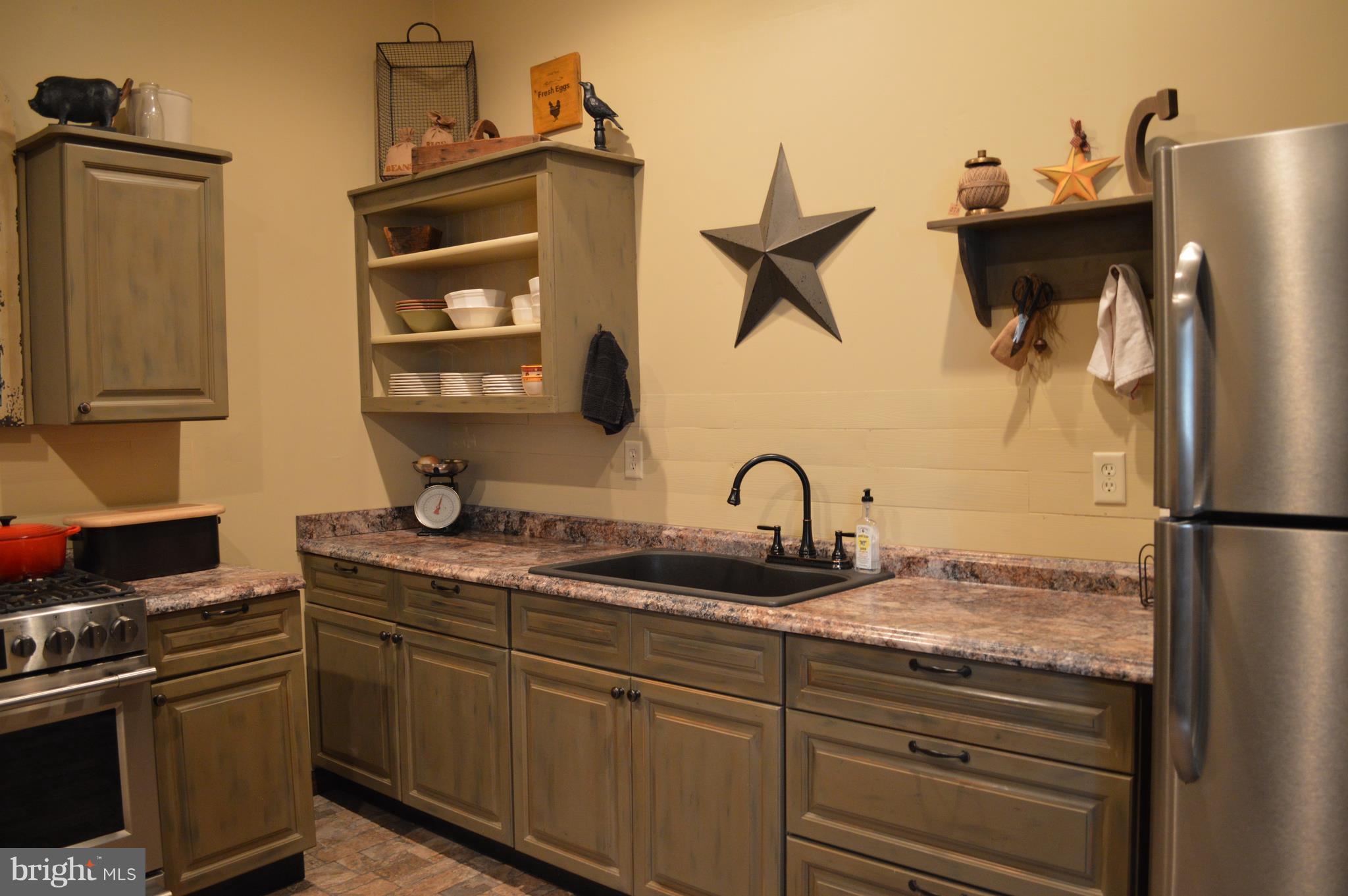 926 County Rte 1/1 Berkeley Springs, WV 25411 - Photo 13 of 26 Open cabinetry displays your most prized cookware