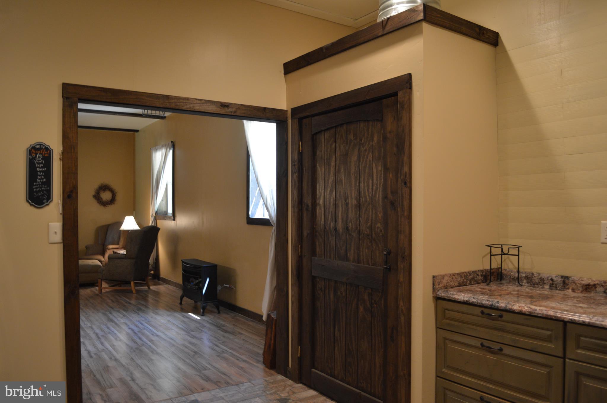 926 County Rte 1/1 Berkeley Springs, WV 25411 - Photo 14 of 26 Kitchen leading to Dining/Greatroom Wide doorways
