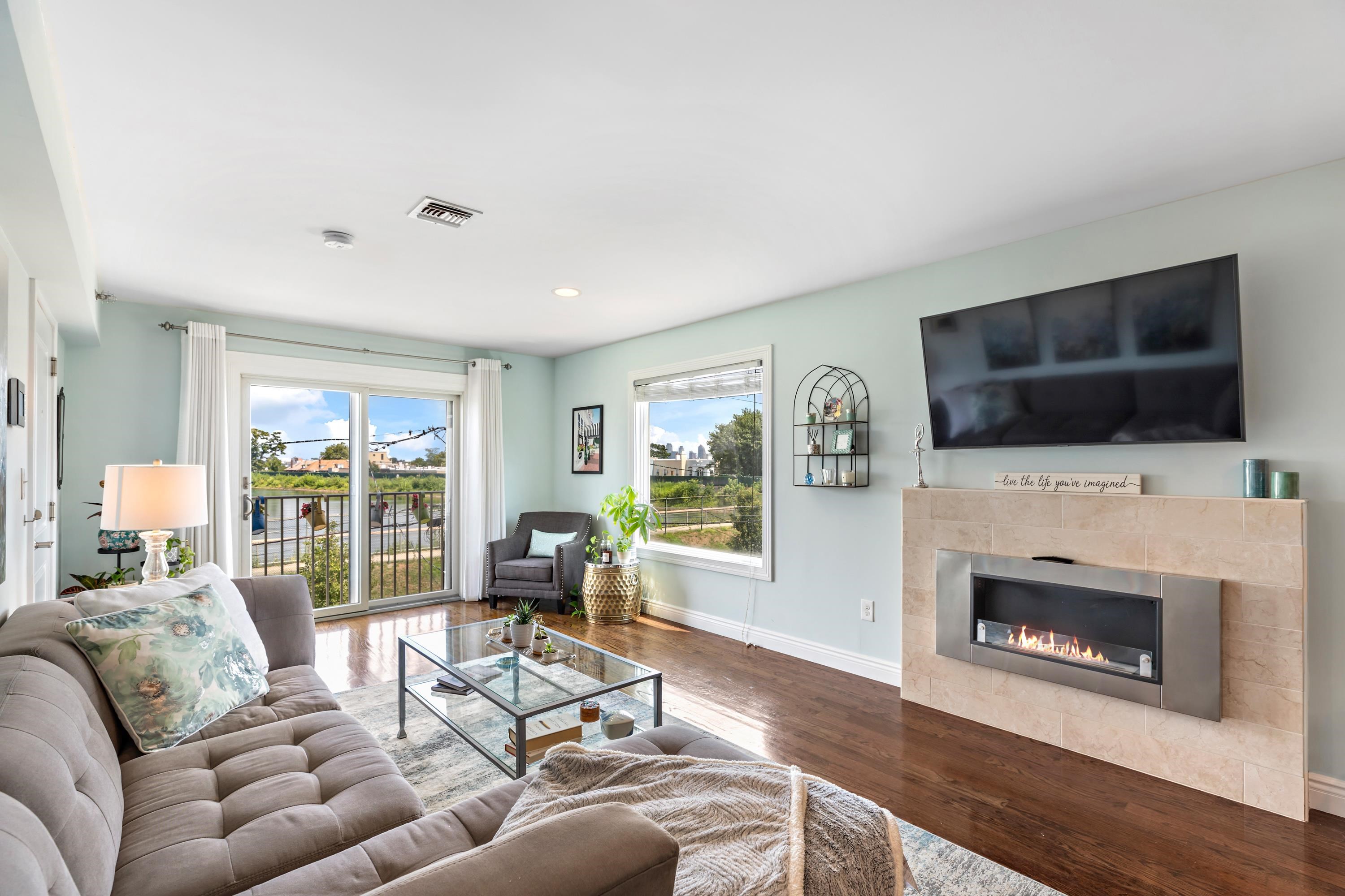 137 20th Street, Unit B Union City, NJ 07087 - Photo 1 of 33 a living room with furniture a flat screen tv and a fireplace