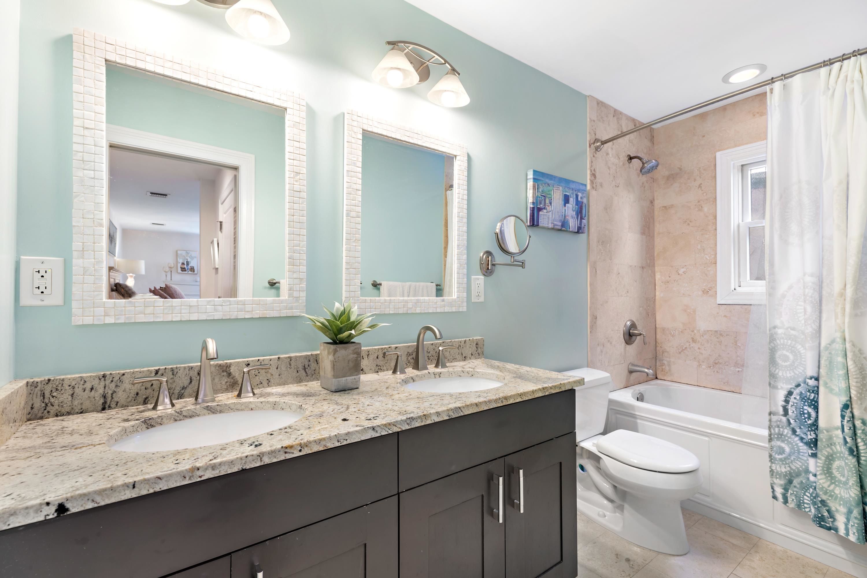 137 20th Street, Unit B Union City, NJ 07087 - Photo 14 of 33 a bathroom with a granite countertop sink toilet a large mirror a shower and a bathtub