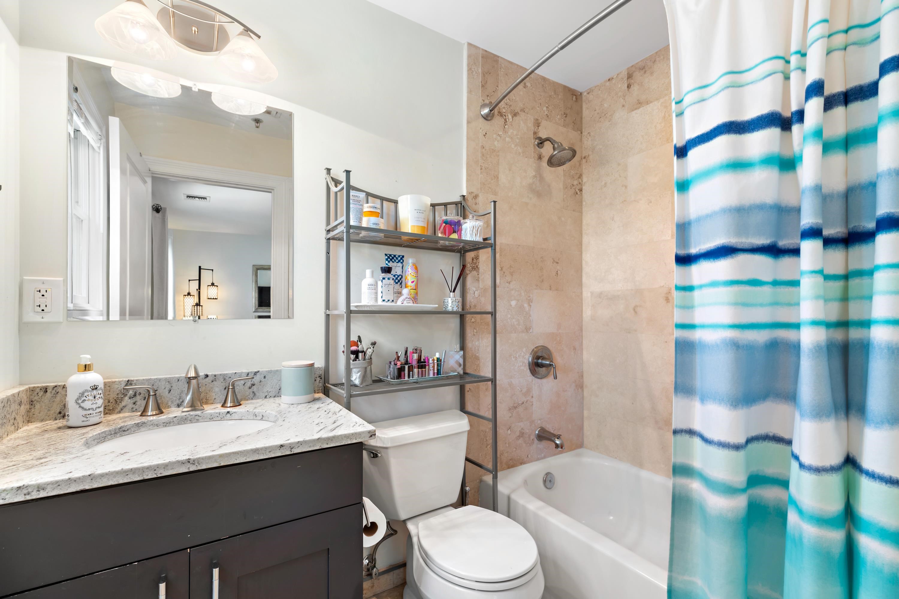 137 20th Street, Unit B Union City, NJ 07087 - Photo 17 of 33 a bathroom with a granite countertop sink toilet and shower