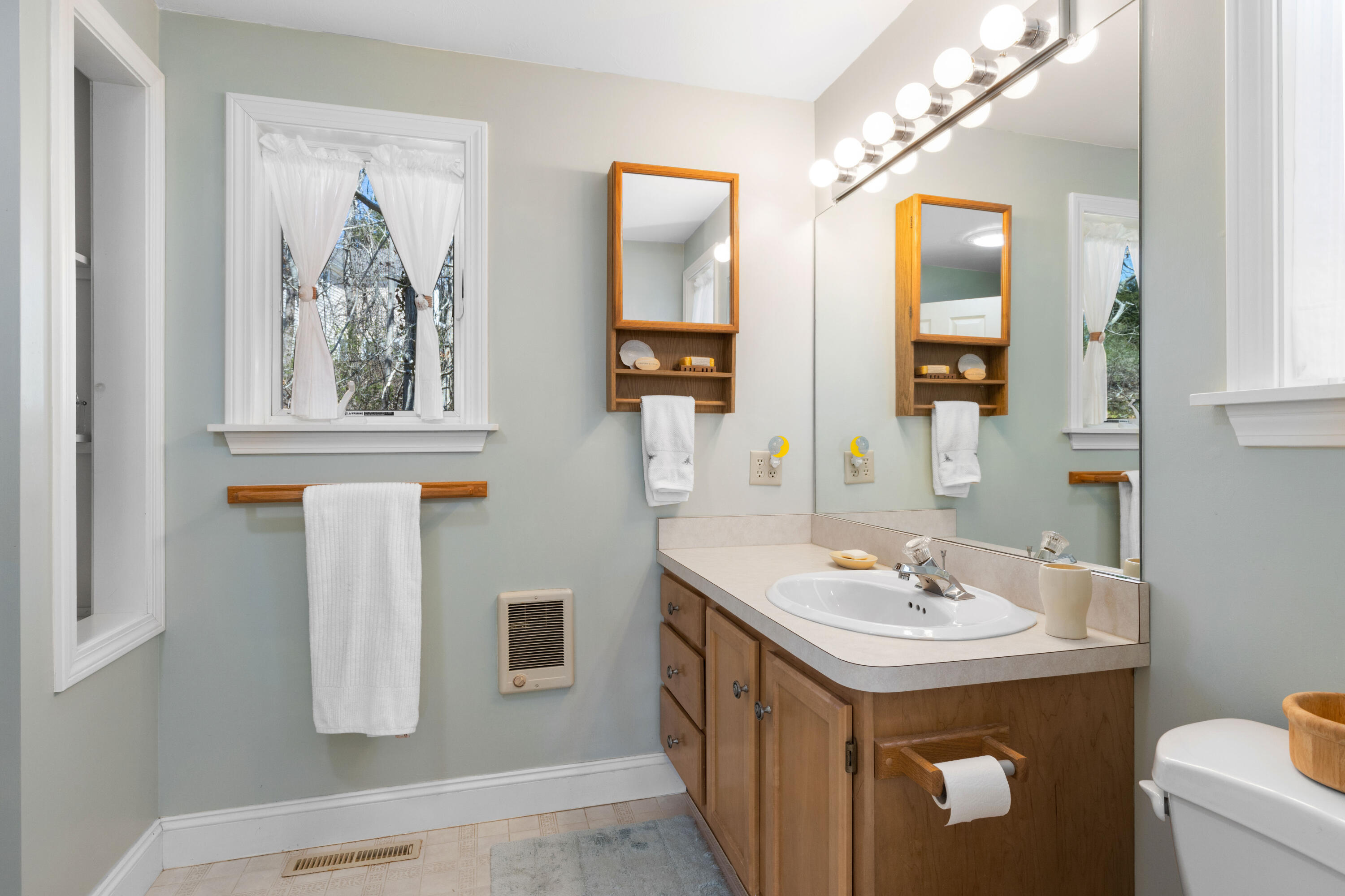 38 Crosswind Farm Road Chatham, MA 02633 - Photo 12 of 36 a bathroom with a double vanity sink and a mirror