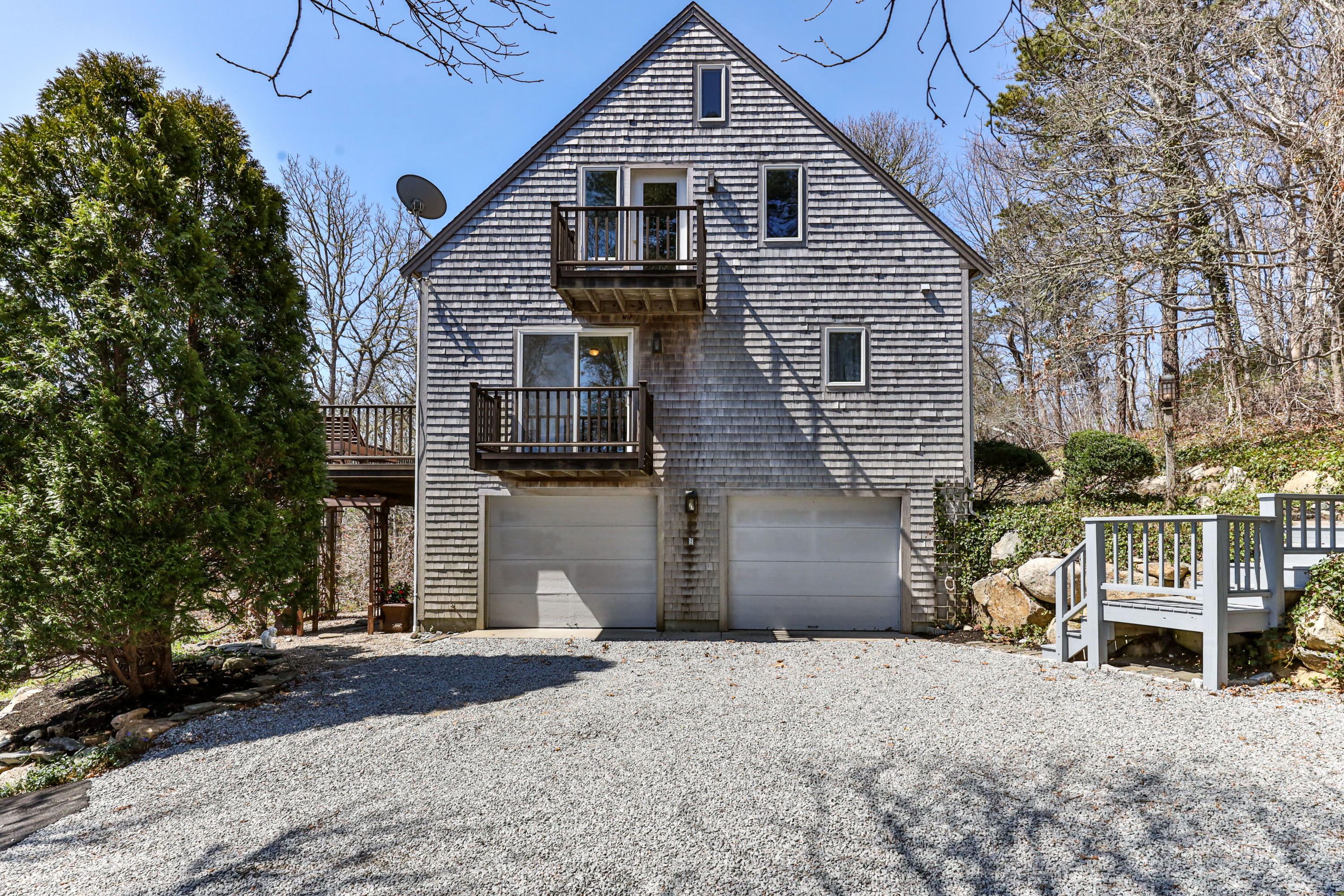 38 Crosswind Farm Road Chatham, MA 02633 - Photo 24 of 36 a front view of a house with a yard and garage