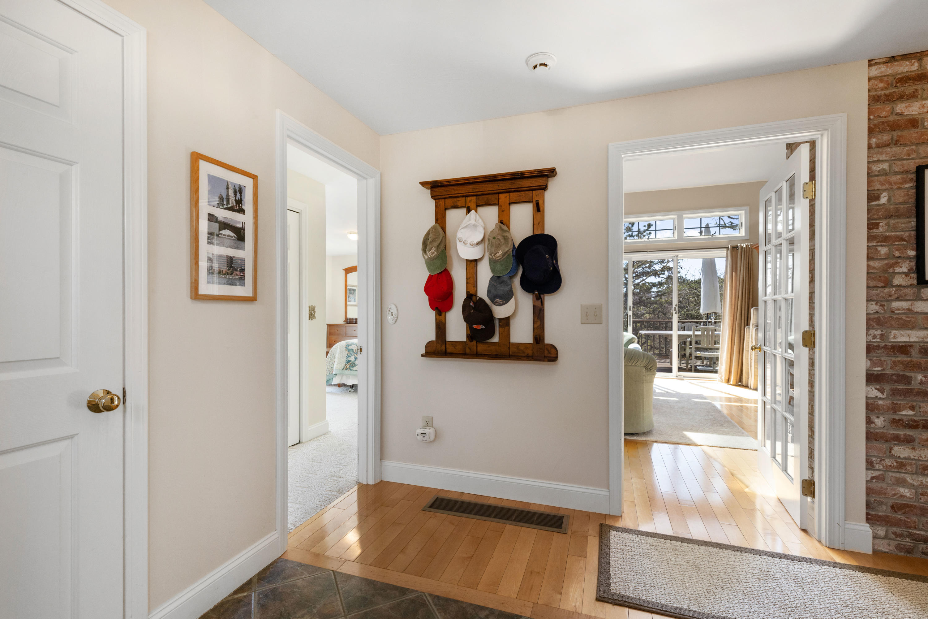 38 Crosswind Farm Road Chatham, MA 02633 - Photo 3 of 36 a view of a hallway with paintings on the wall