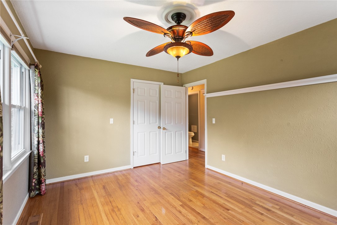 202 Keowee Trail Seneca, SC 29672 - Photo 17 of 35 This spacious bedroom features lustrous hardwood floors and abundant natural light from a large window.