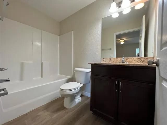 a bathroom with a sink toilet a mirror and shower