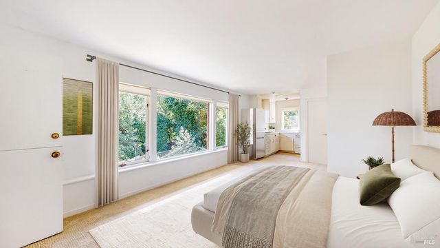 a bedroom with a large bed and a large window