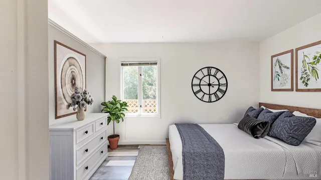 a bedroom with a bed and a potted plant