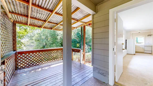 a view of balcony with wooden floor and fence