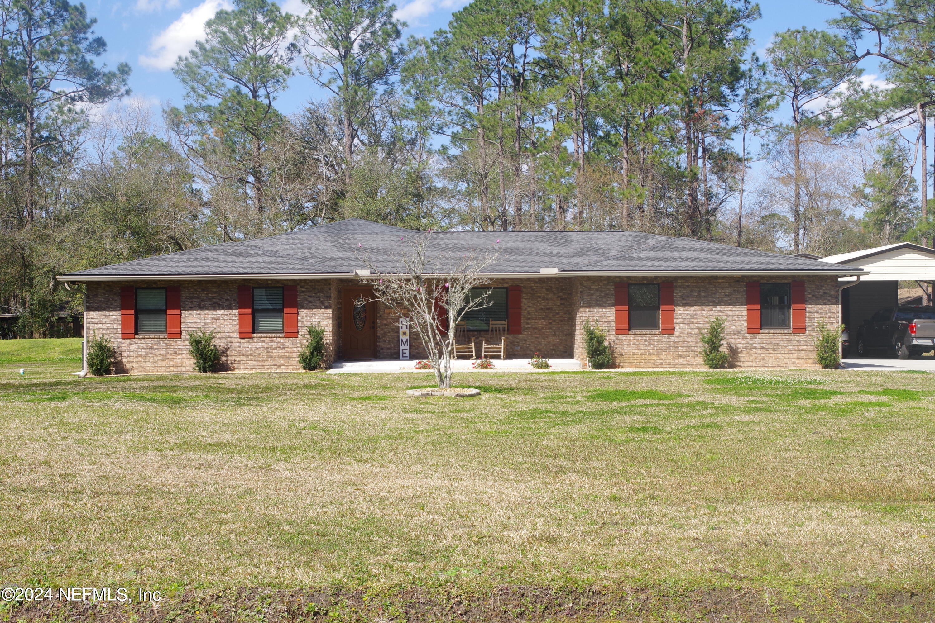54065 Howard Road Callahan, FL 32011 - Photo 1 of 69 a front view of a house with a yard and trees