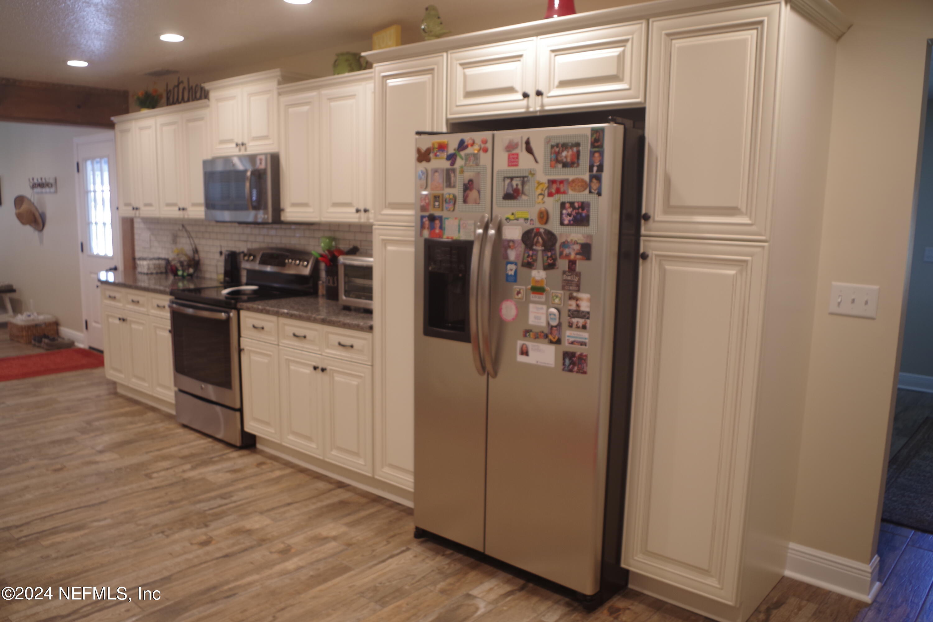 54065 Howard Road Callahan, FL 32011 - Photo 14 of 69 a kitchen with stainless steel appliances a refrigerator sink and microwave