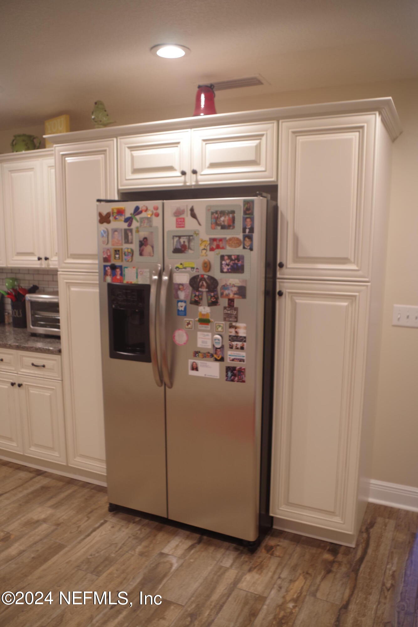 54065 Howard Road Callahan, FL 32011 - Photo 15 of 69 a view of a refrigerator in kitchen and an empty room