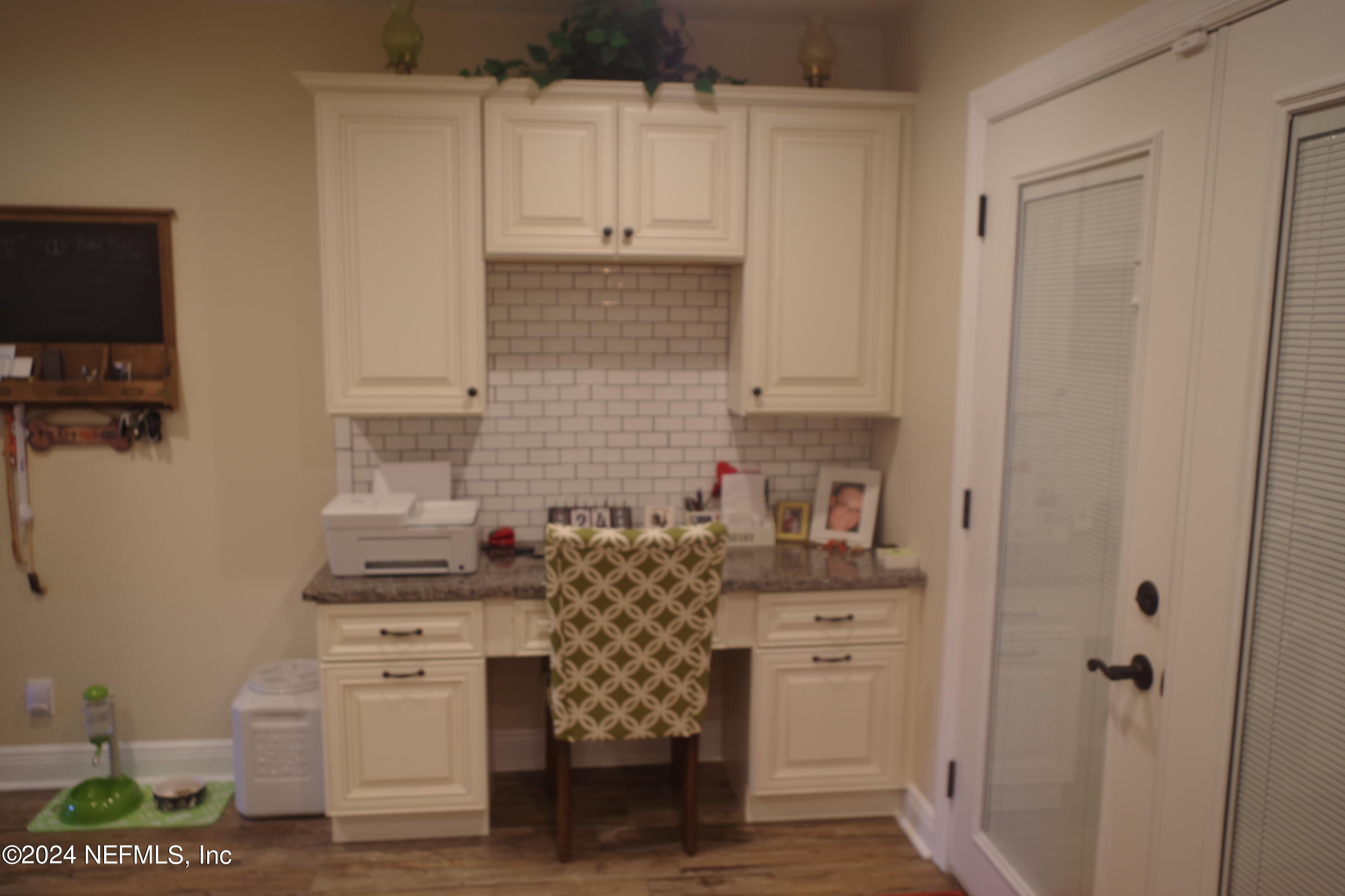 54065 Howard Road Callahan, FL 32011 - Photo 17 of 69 a kitchen with cabinets and wooden floor