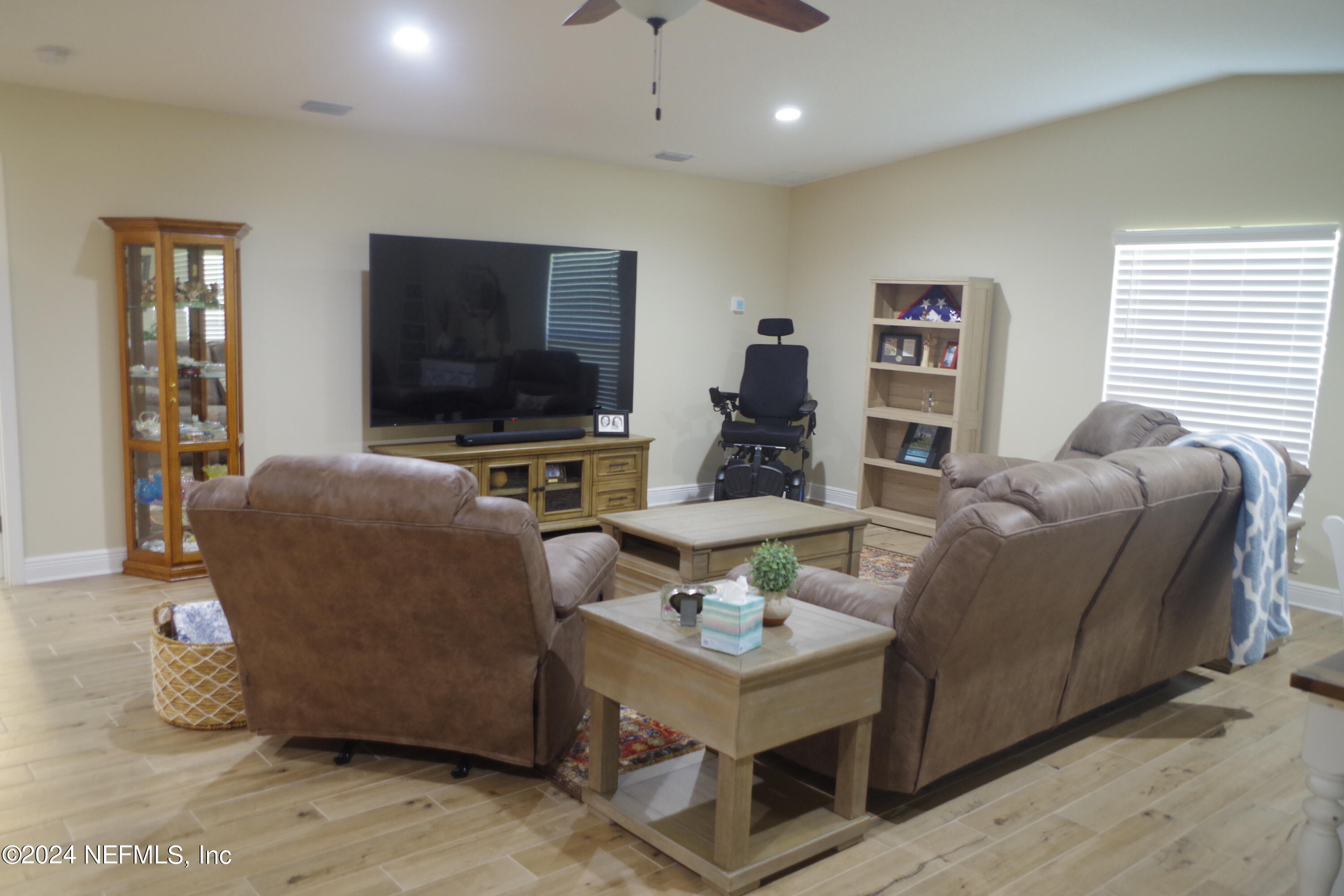54065 Howard Road Callahan, FL 32011 - Photo 20 of 69 a living room with furniture and a flat screen tv