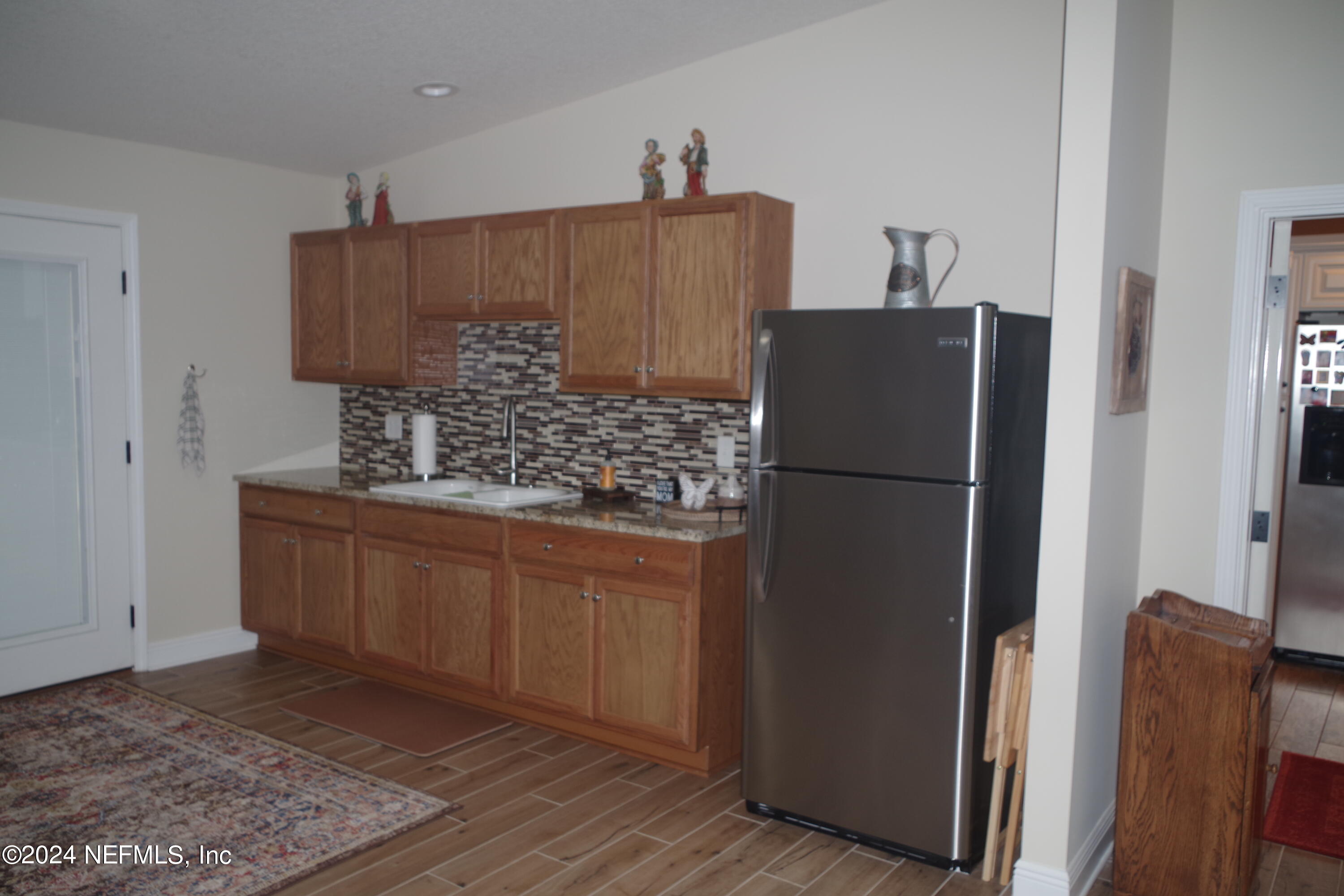54065 Howard Road Callahan, FL 32011 - Photo 32 of 69 a kitchen with stainless steel appliances granite countertop a refrigerator and a sink