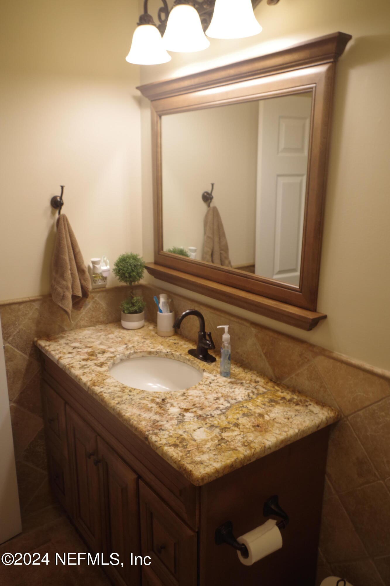 54065 Howard Road Callahan, FL 32011 - Photo 36 of 69 a bathroom with a granite countertop sink and a mirror