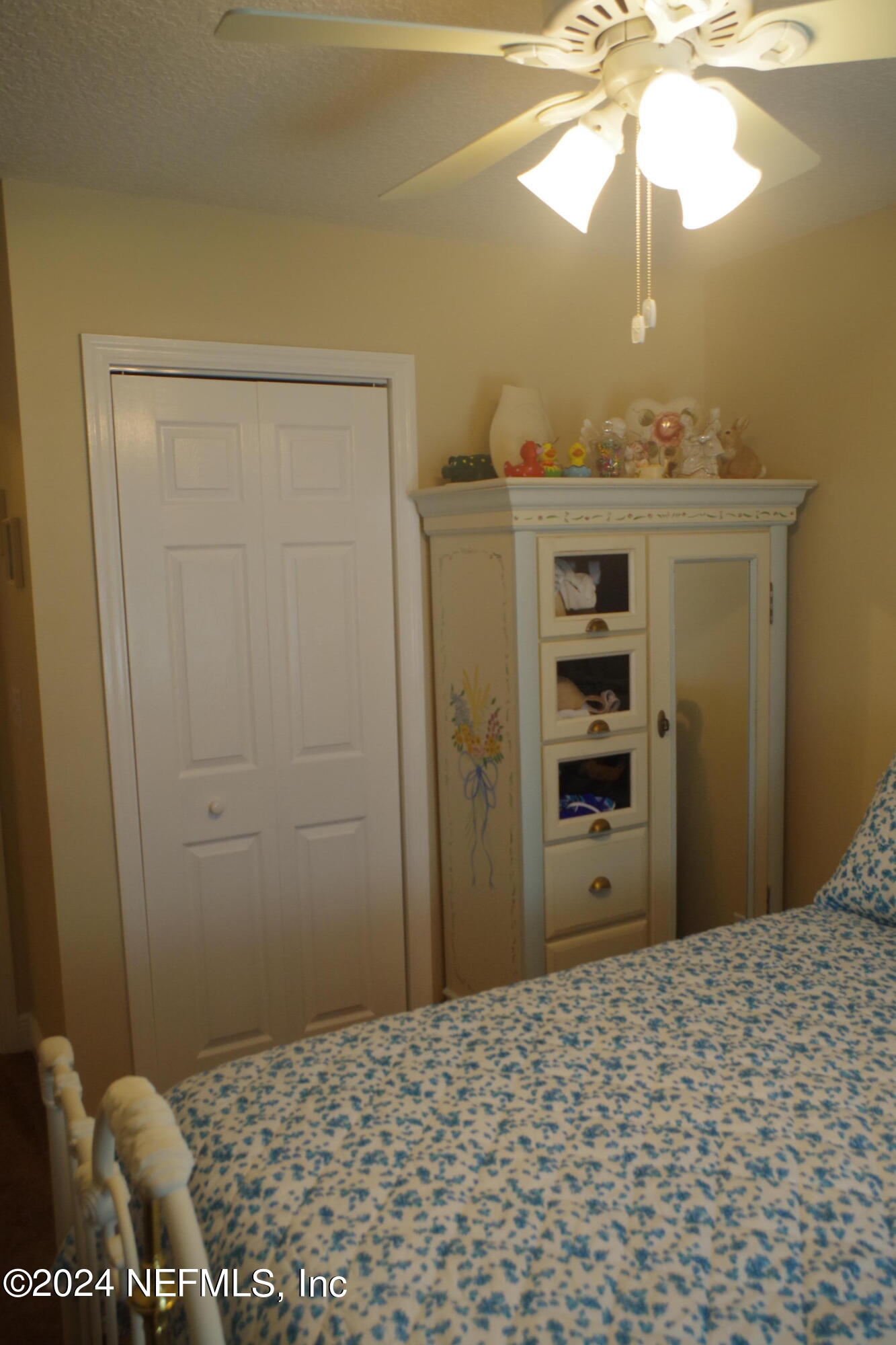 54065 Howard Road Callahan, FL 32011 - Photo 38 of 69 a bedroom with a bed and a chandelier