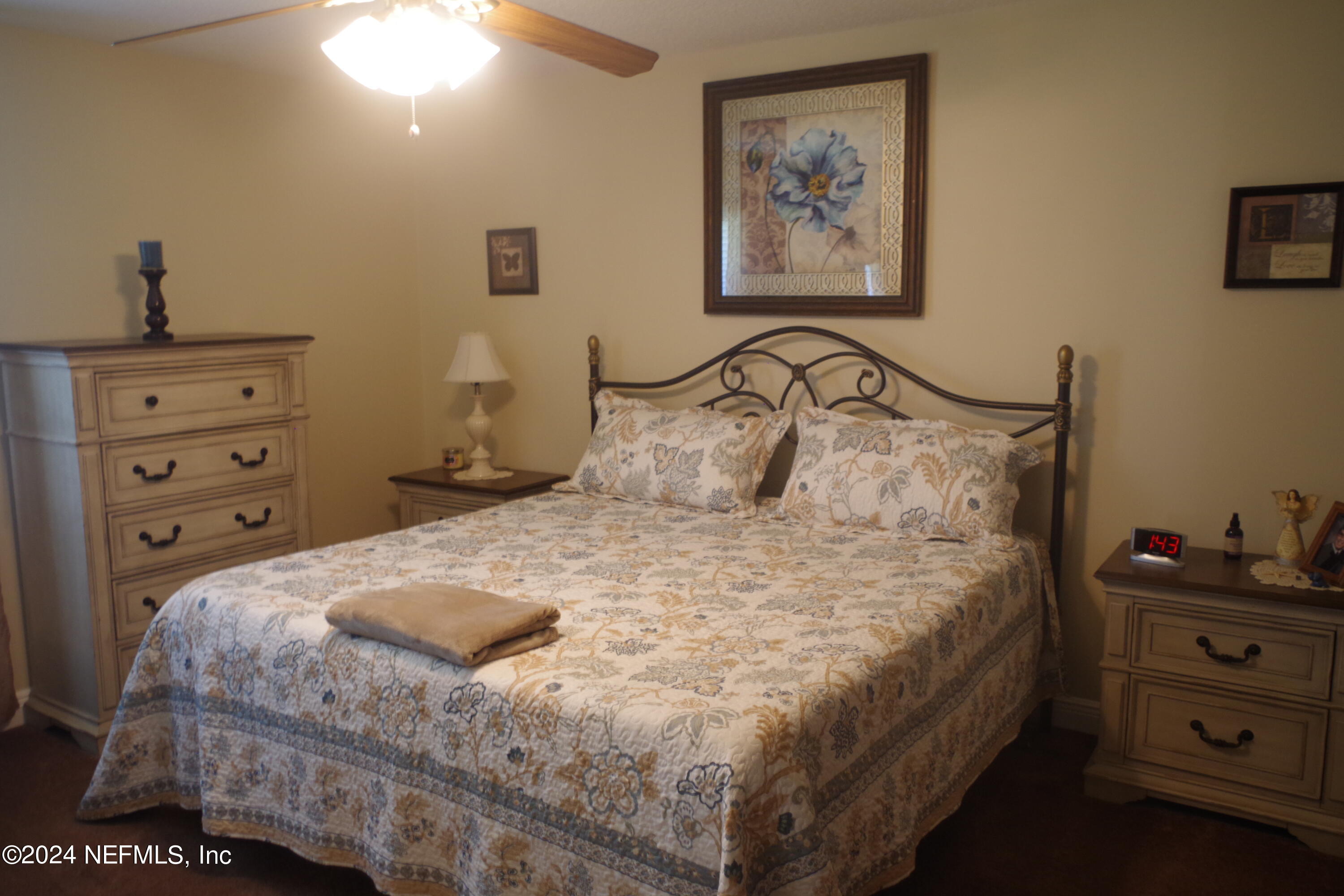 54065 Howard Road Callahan, FL 32011 - Photo 49 of 69 a bedroom with a bed and a night stand