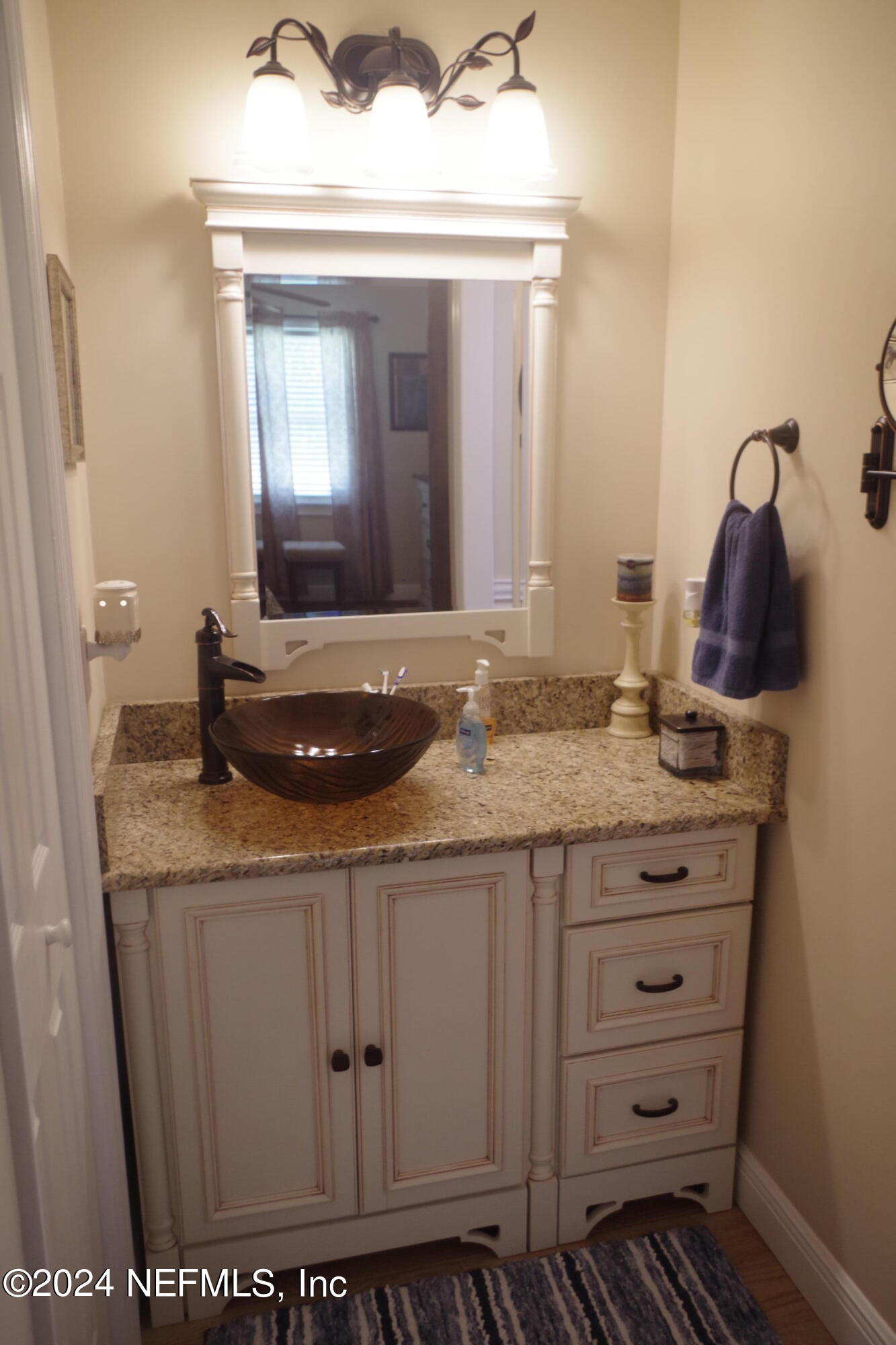 54065 Howard Road Callahan, FL 32011 - Photo 54 of 69 a bathroom with a granite countertop sink and a mirror