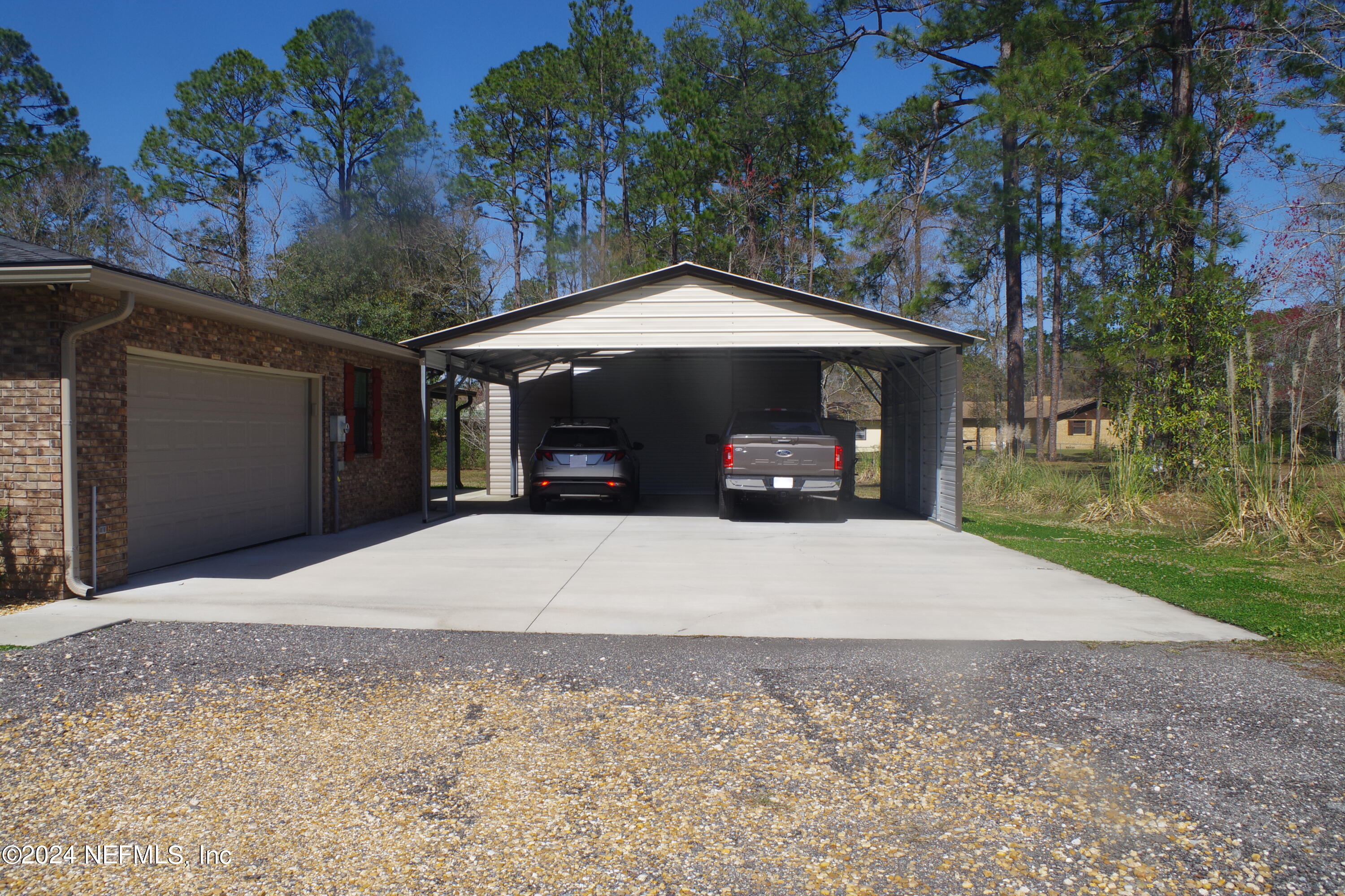 54065 Howard Road Callahan, FL 32011 - Photo 66 of 69 a front view of a house with a yard and garage