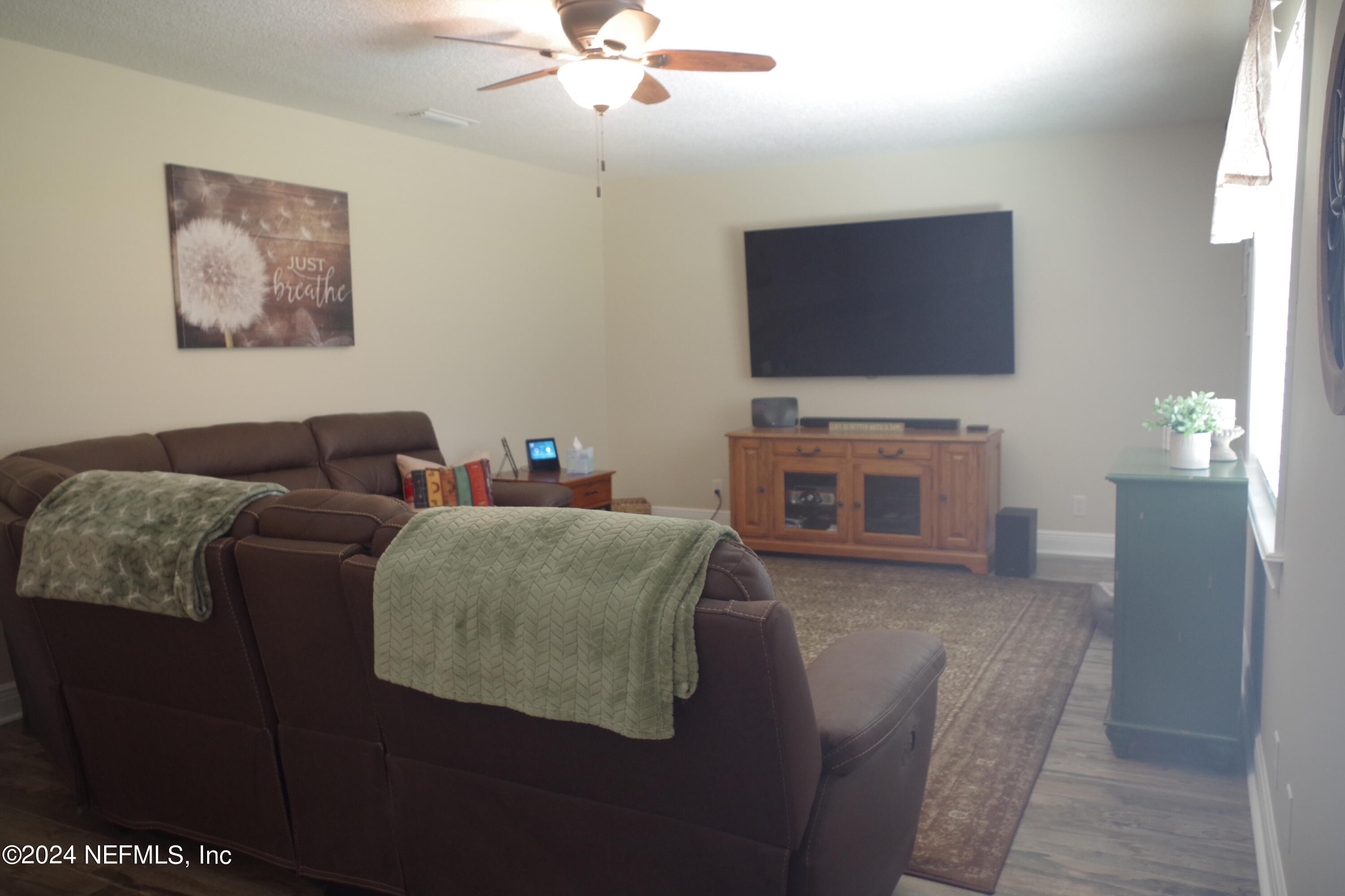 54065 Howard Road Callahan, FL 32011 - Photo 7 of 69 a living room with furniture and a flat screen tv