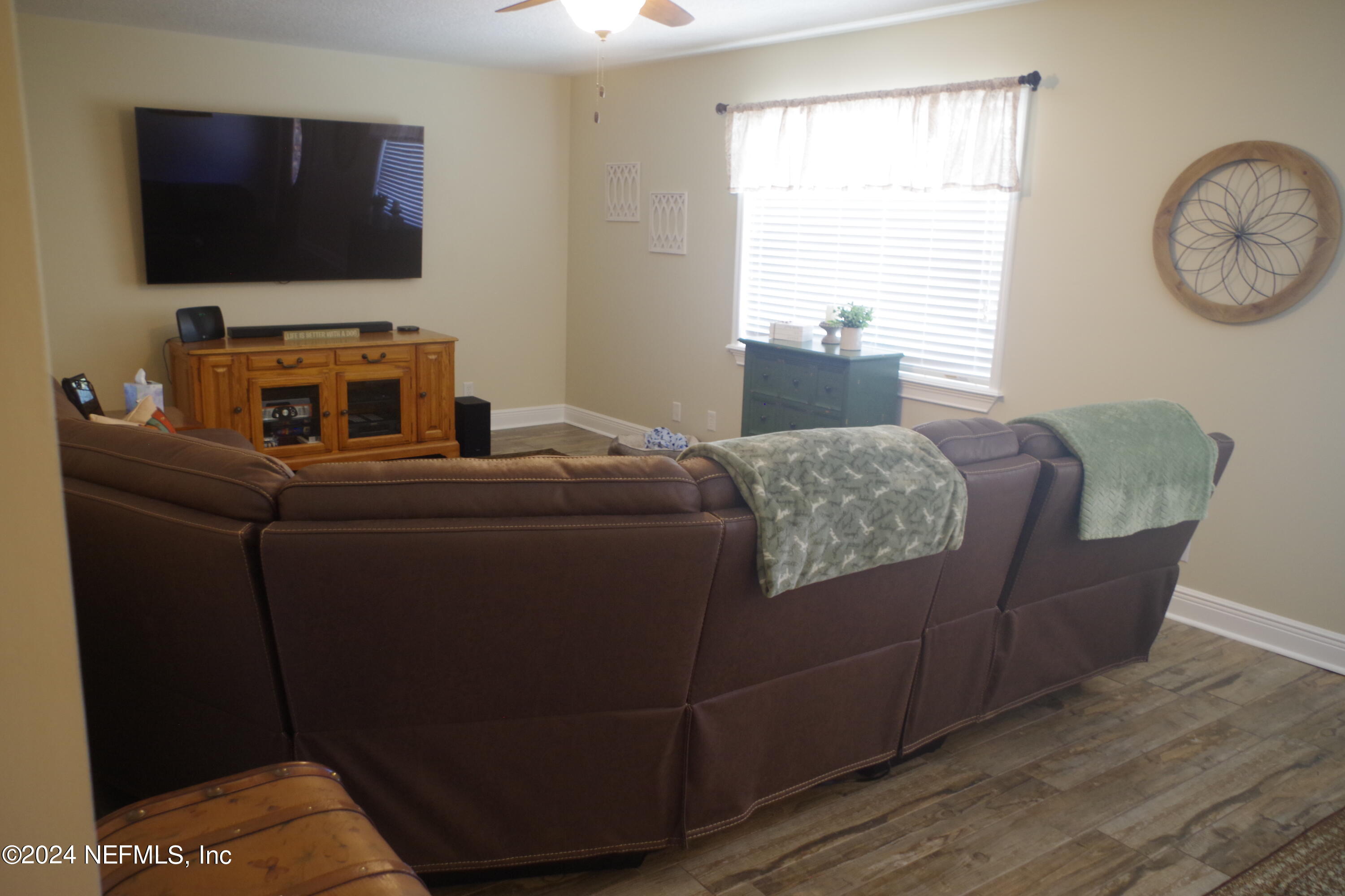 54065 Howard Road Callahan, FL 32011 - Photo 8 of 69 a living room with furniture and a flat screen tv