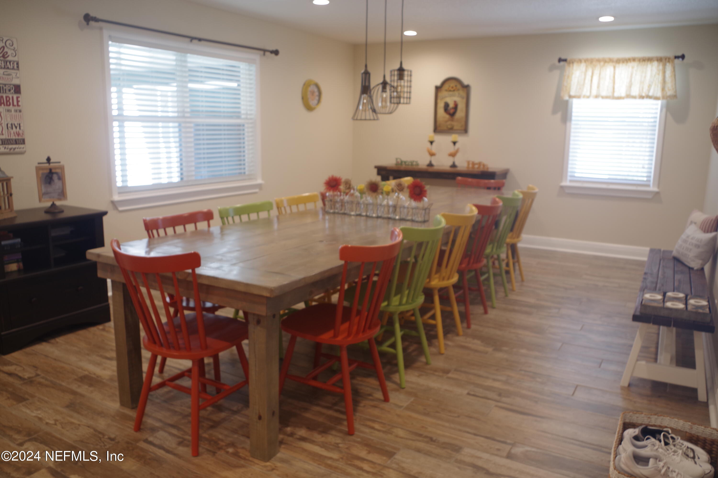 54065 Howard Road Callahan, FL 32011 - Photo 10 of 69 a view of a dining room with furniture and wooden floor