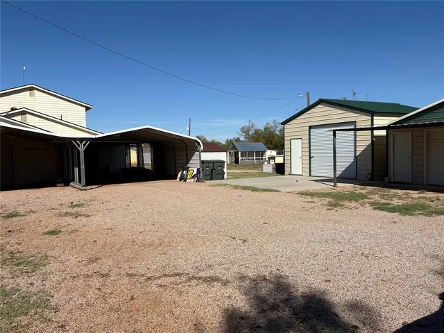 a view of a wooden house with a yard