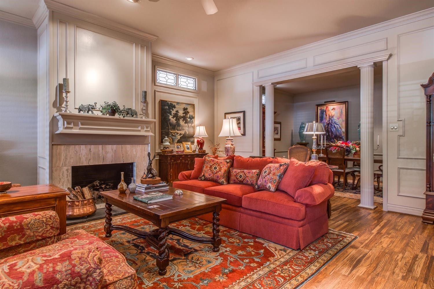 4407 7th Street Lubbock, TX 79416 - Photo 6 of 10 a living room with furniture a fireplace and a dining table with wooden floor