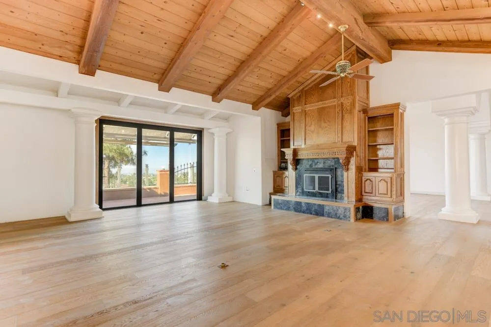 1762 Kings Road Vista, CA 92084 - Photo 11 of 24 a view of an empty room with wooden floor and a window