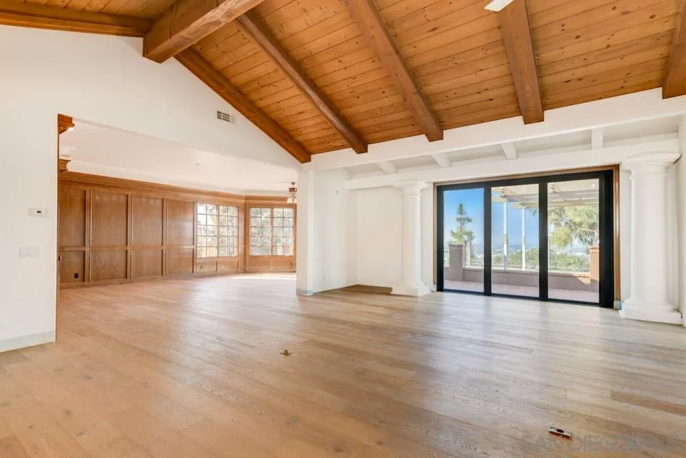 1762 Kings Road Vista, CA 92084 - Photo 12 of 24 a view of an empty room with wooden floor and a window