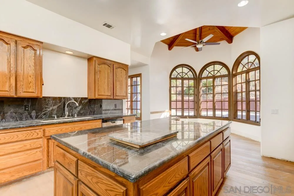 1762 Kings Road Vista, CA 92084 - Photo 13 of 24 a kitchen with a stove a sink and cabinets