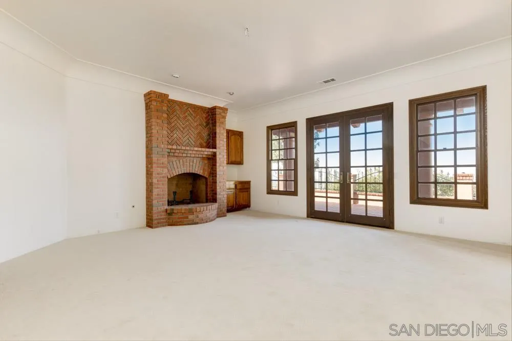 1762 Kings Road Vista, CA 92084 - Photo 16 of 24 a view of an empty room with a fireplace and a window
