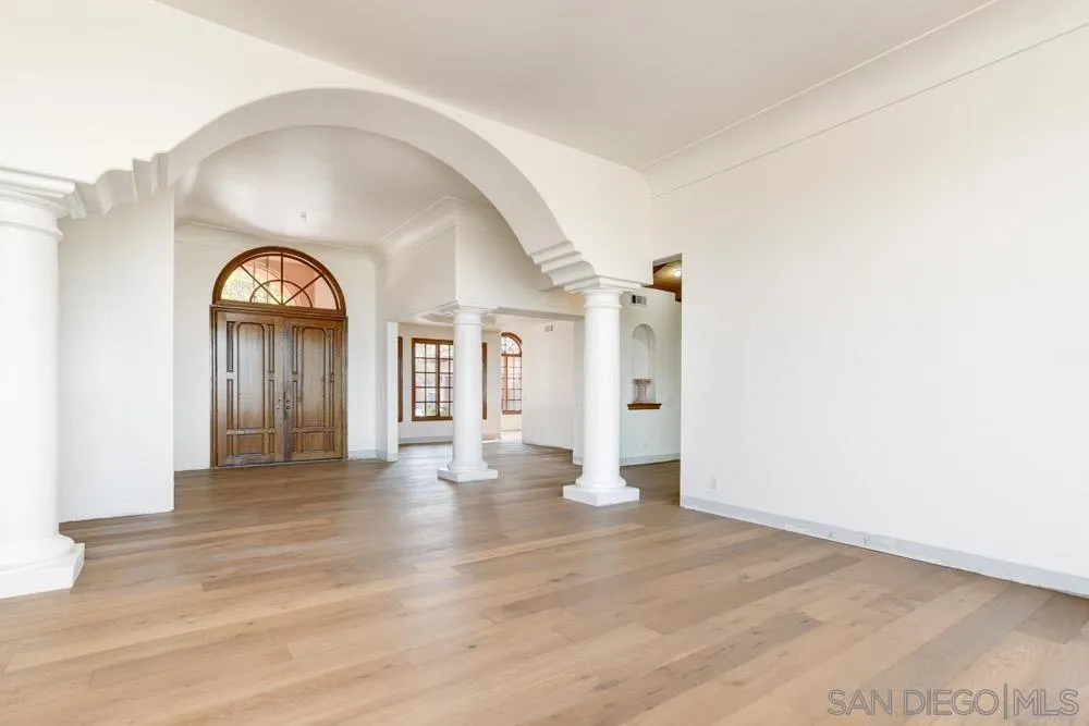 1762 Kings Road Vista, CA 92084 - Photo 4 of 24 an empty room with wooden floor and a window