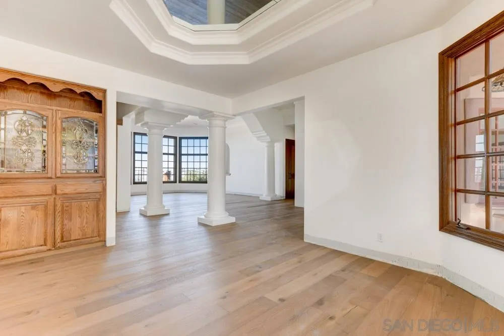 1762 Kings Road Vista, CA 92084 - Photo 7 of 24 a view of an empty room with wooden floor and a window