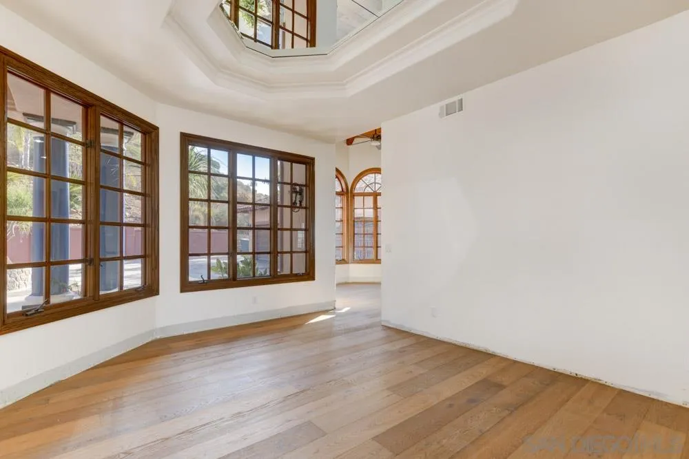 1762 Kings Road Vista, CA 92084 - Photo 8 of 24 a view of an empty room with a window and wooden floor