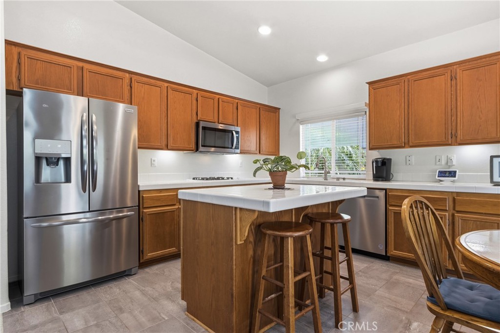 33145 Vermont Road Temecula, CA 92592 - Photo 15 of 41 a kitchen with stainless steel appliances granite countertop a refrigerator and a stove top oven