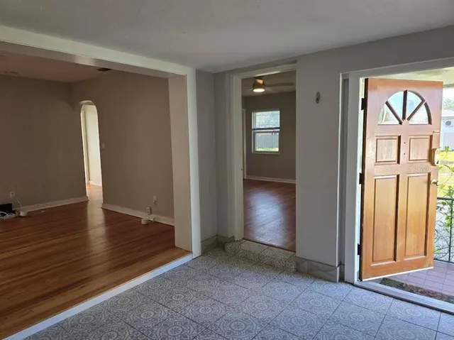 an empty room with windows and entrance