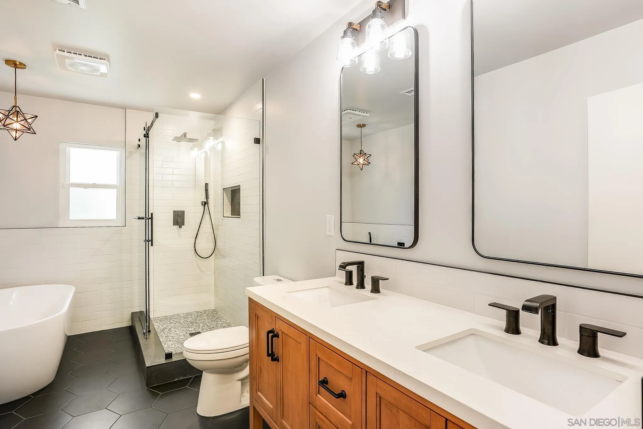 2211 Sunset Drive Escondido, CA 92025 - Photo 20 of 43 a bathroom with a double vanity sink toilet mirror and shower