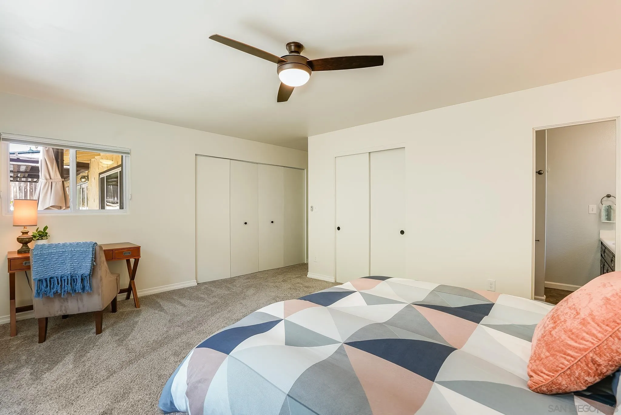 2211 Sunset Drive Escondido, CA 92025 - Photo 23 of 43 a bedroom with a bed and a couch