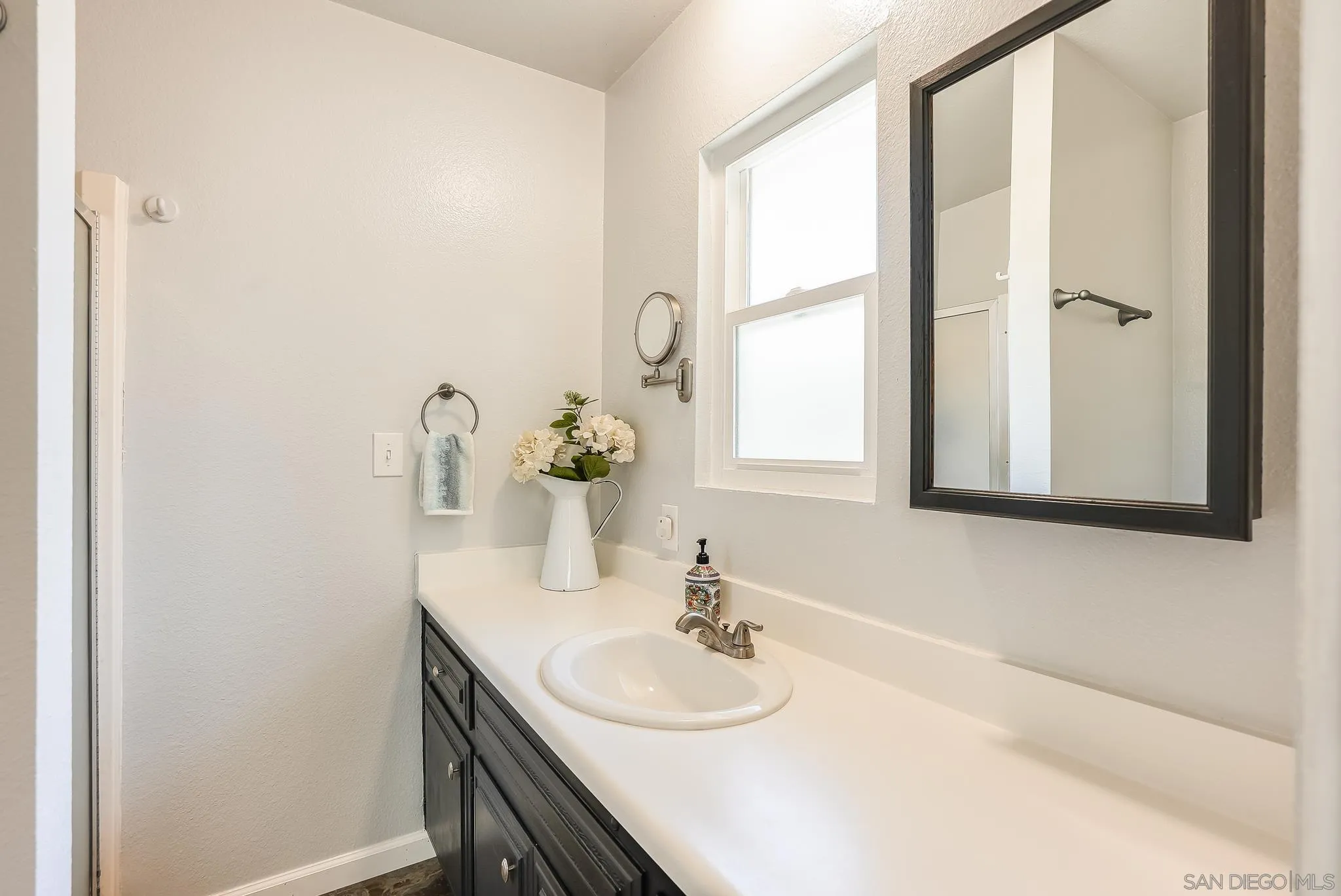2211 Sunset Drive Escondido, CA 92025 - Photo 24 of 43 a bathroom with a sink and a mirror