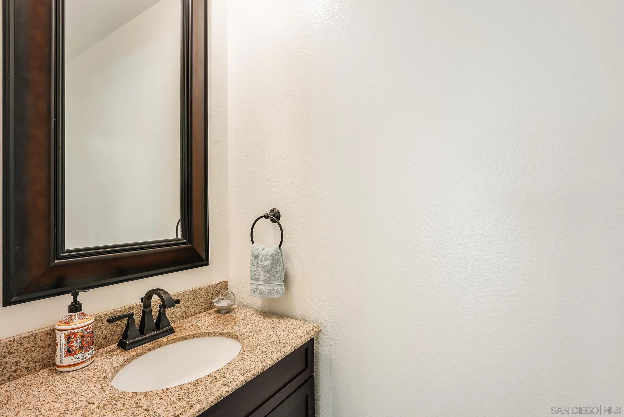 2211 Sunset Drive Escondido, CA 92025 - Photo 29 of 43 a bathroom with a sink and a mirror